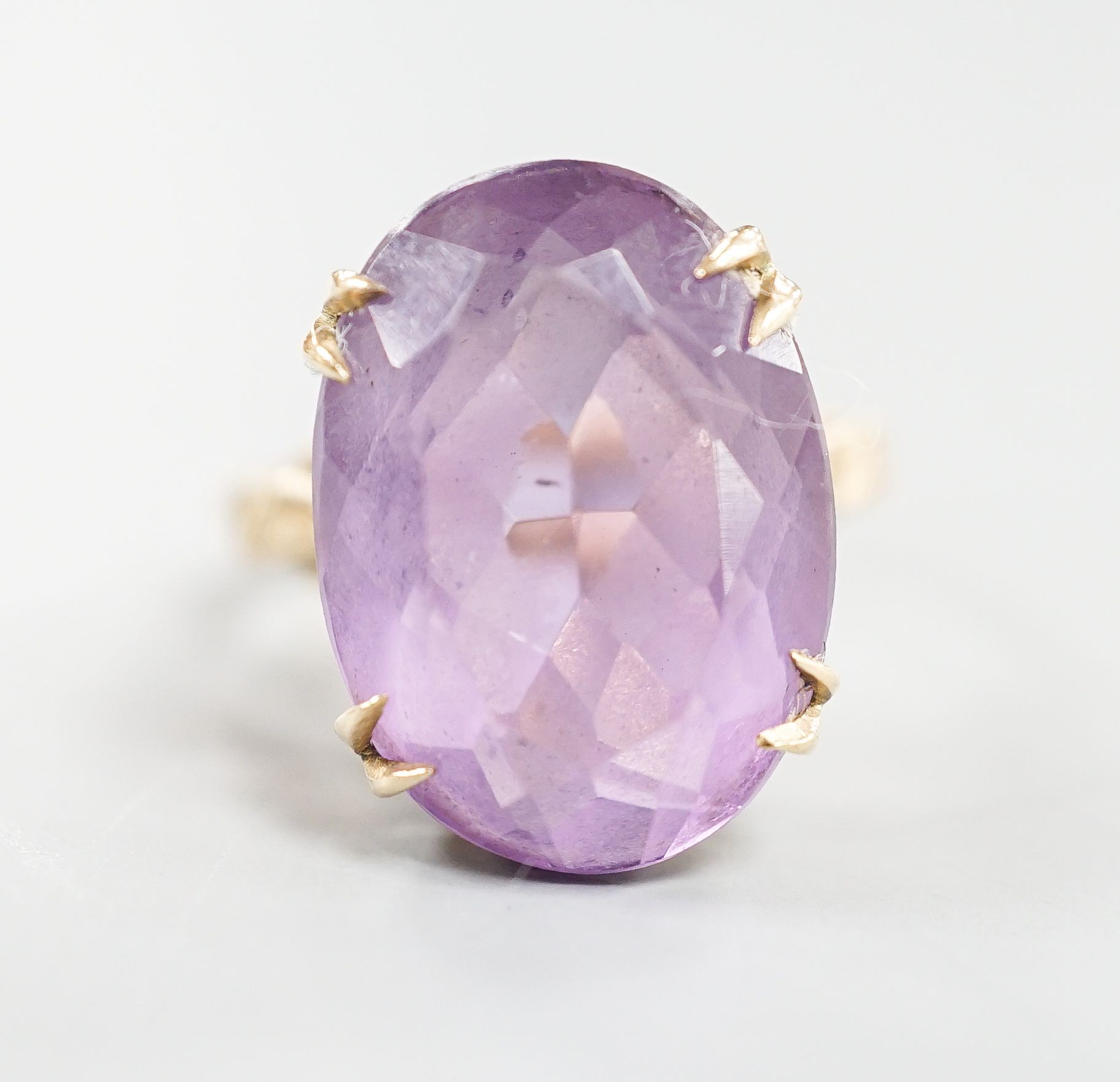 A modern 9ct gold and oval cut amethyst set dress ring, size L/M, gross weight 5.7 grams.
